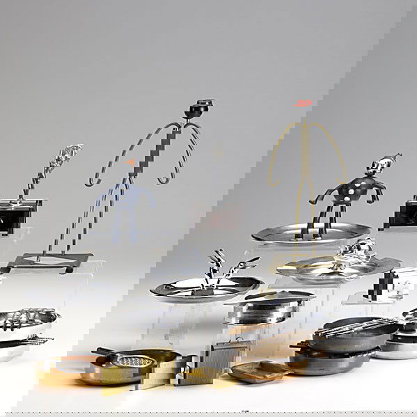 ART DECO SMOKING ACCESSORIES: ART DECO SMOKING ACCESSORIES; Thirteen pieces include Dunhill cigarette lighter, Bakelite base with Frankart nude finial, brass valet match holder and aashtray, Manning & Bowman clown ashtray, five sp