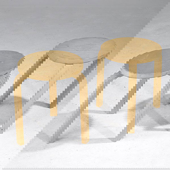 ALVAR AALTO / ARTEK: ALVAR AALTO; ARTEK; Two birch stacking tables, late 1950s; One stamped Artek Made in Finland; 17 1/4'' x 13 3/4'' dia.