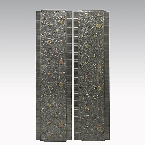 STYLE OF EDGAR BRANDT; Pair of panels: STYLE OF EDGAR BRANDT; Pair of iron, copper and brass architectural panels; Unmarked; Each 57 3/4'' x 15 1/2''