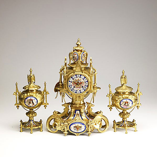FRENCH CLOCK SET: FRENCH CLOCK SET; Three piece, in dore bronze with porcelain Sevres plaques, time and strike movement, ca. 1900; Signed Vincente Cie; 11'' x 17 1/2'' x 7 1/2''
