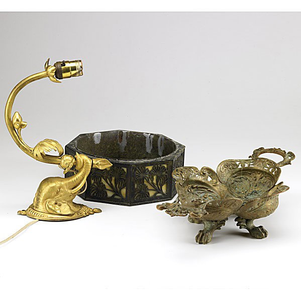 20TH C. DECORATIVE GROUPING: 20TH C. DECORATIVE GROUPING; Three pieces: dore bronze elephant wall sconce, two-handled brass bowl with putti decoration on four claw feet and Tiffany style bronze bowl with slag glass panels; Longes