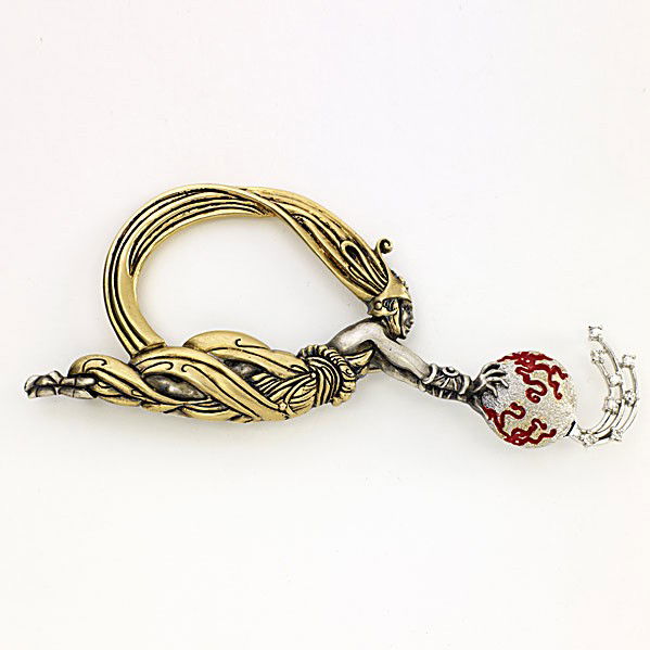 ERTE FIREFLIES STATE I BROOCH: ERTE FIREFLIES STATE I BROOCH Female figure rendered in 14k yg and sterling supports enameled globe with diamond trail, #42/125. With signature Art Deco purse and signed certificate. 24 gs. 3 3/4''