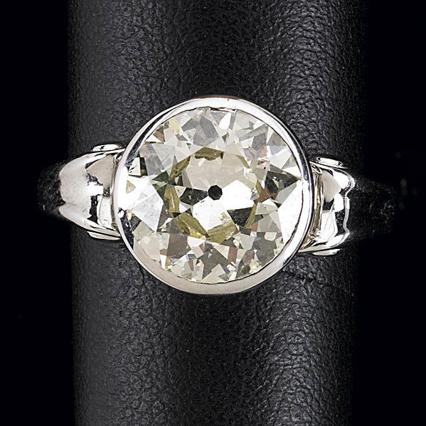 ART DECO DIAMOND SOLITAIRE: ART DECO DIAMOND SOLITAIRE OEC diamond, 10mm, approx. 3 cts., bezel-set on pierced carriage, volute shoulders, size 8