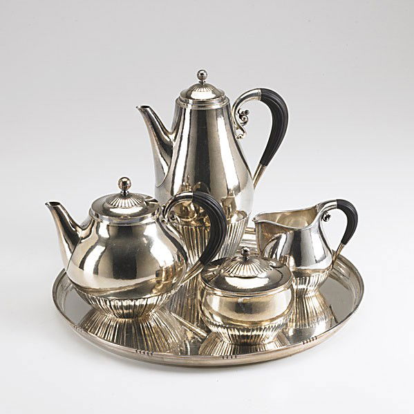 GEORG JENSEN SILVER AND EBONY TEA SERVICE: GEORG JENSEN SILVER AND EBONY COFFEE AND TEA SERVICE Designed by Johan Rohde. Spot-hammered bulbous forms, half reeded with ball finials and fluted ebony handles. 9 1/2'' coffee pot #45A; 6'' tea pot