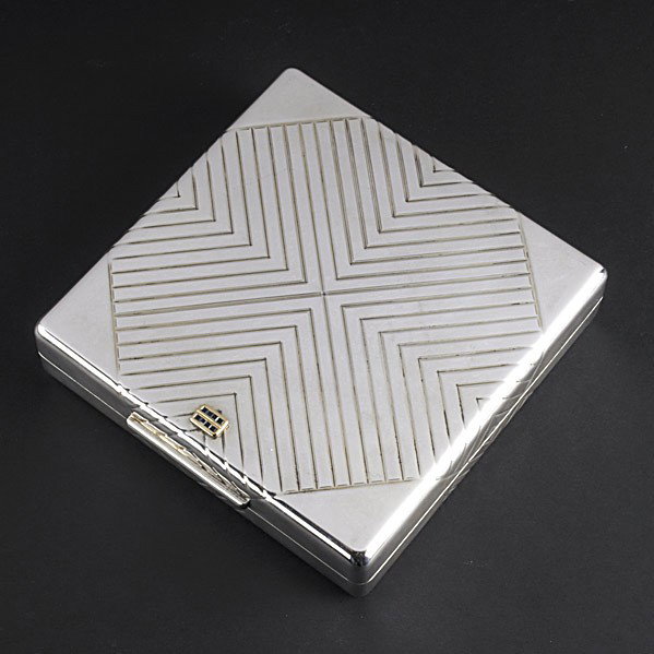 TIFFANY & CO. SILVER CIGAR BOX: TIFFANY & CO. SILVER CIGAR BOX Incised over-edge handkerchief decorations, the cover with gold and calibre sapphire ornaments. 25.26 OT. 6'' x 6''