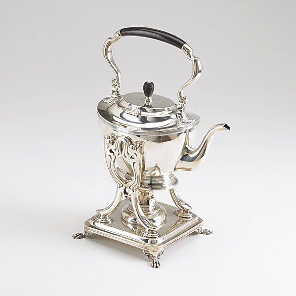 TIFFANY & CO. SILVER KETTLE ON STAND: TIFFANY & CO. SILVER KETTLE ON STAND, 1894. Oval form with reeded border and ring foot, gooseneck spout, swing handle issues from shell terminus, ebony grip and finial. Square stand on four paw-feet, 