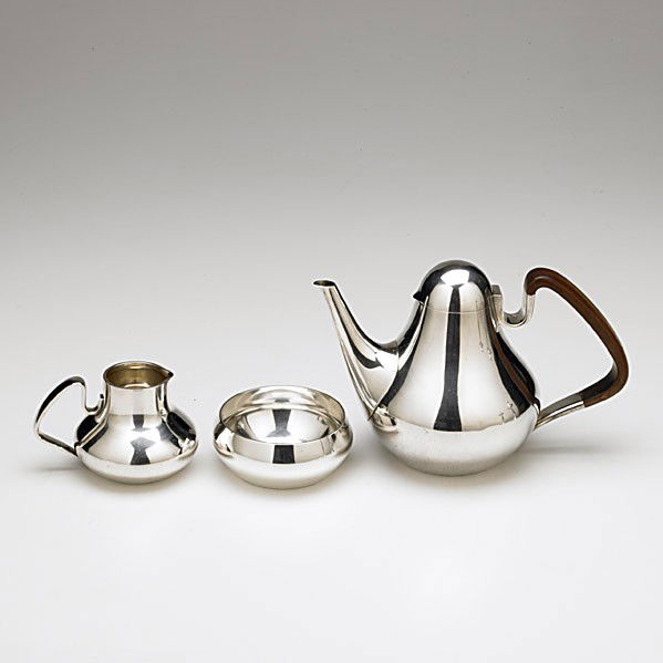 GEORG JENSEN SILVER SERVICE BY HENNING KOPPEL: GEORG JENSEN SILVER COFFEE SERVICE BY HENNING KOPPEL, DENMARK. 1947-1977. Three pieces #1017: 6 1/2" pear-shape coffee pot with rosewood handle; 3" cream pitcher; 1 3/4" x 4 1/2" open sugar bowl. 37.4