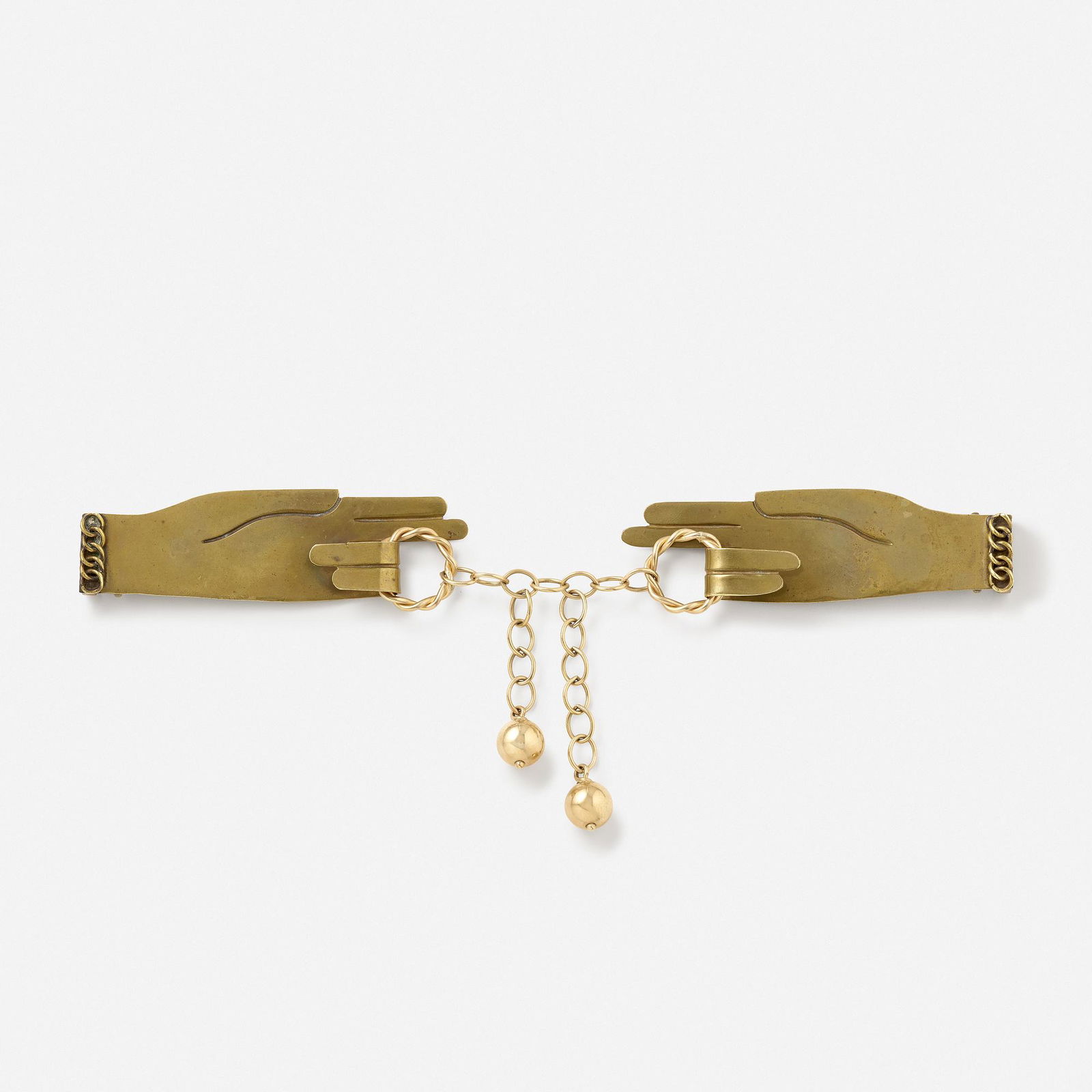 Hubert Harmon, Buckle: Hubert Harmon Buckle Designed as two hands joined by roped rings with ball and chain tassel; circa 1950s Brass and low karat yellow gold Signed Hubert Harmon 9.50 x 4.75 in; Gross weight 46.8 dwts