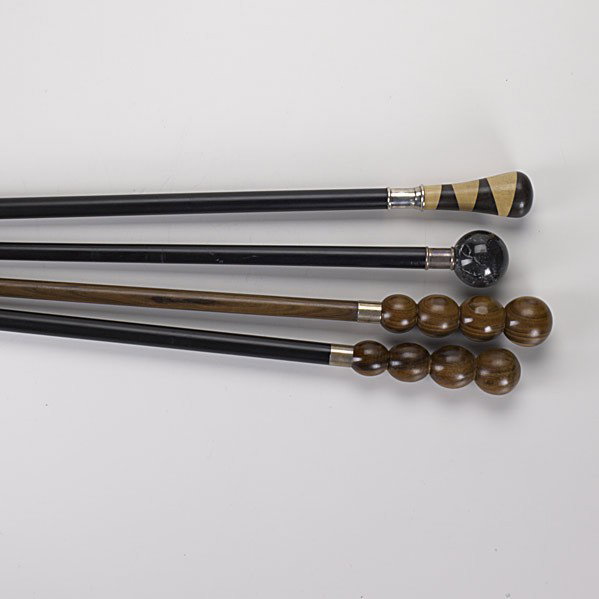 FLANN LIPPINCOTT SILVER MOUNTED WALKING STICKS: FLANN LIPPINCOTT FOUR SILVER MOUNTED WALKING STICKS; Italy, ca. 2000; Cannonball turned black marble; turned inlaid birch and walnut; two cannonball turned rosewood, one with ebonized stick and horn t