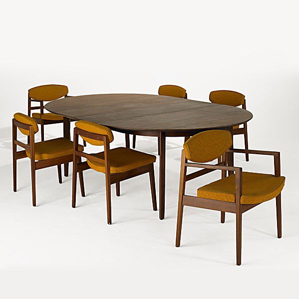 EDWARD WORMLEY; DUNBAR; GEORGE NELSON; HERMAN MILL: EDWARD WORMLEY; DUNBAR; GEORGE NELSON; HERMAN MILLER; Walnut dining table together with six walnut dining chairs, two with arms; Table has rectangular brass Dunbar tag; Chairs have a foil Herman Mille