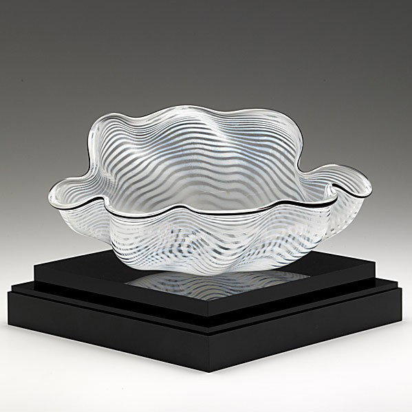 DALE CHIHULY: DALE CHIHULY; White, clear and black glass seaform basket, 1990; On black lucite stand with clear cover; Dedicated, signed and dated; As shown: 6'' x 12''
