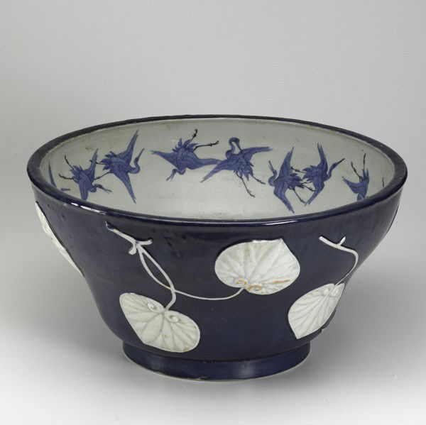 JAPANESE DEEP BOWL: JAPANESE DEEP BOWL; Dark blue with exterior lotus leaf decoration and flying storks on the interior, early 20th c.; 10'' x 18 1/2''