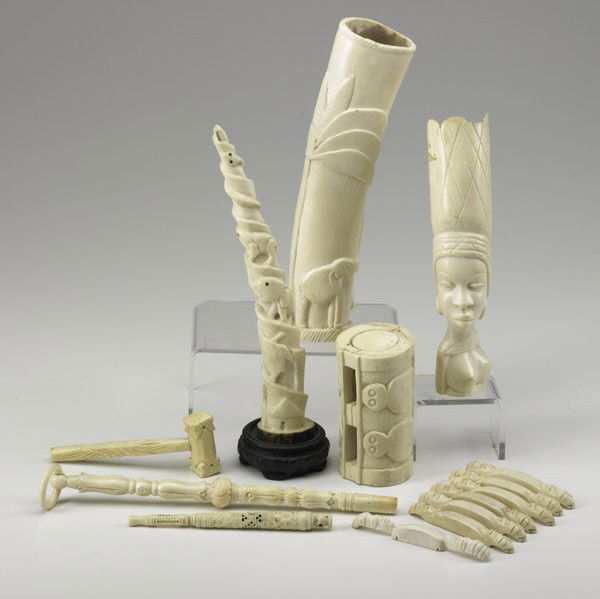 IVORY GROUPING: IVORY GROUPING; Fourteen pieces include carved totem, African bust, elephant carving in relief, etc., 20th c.; Largest: 9 1/2''