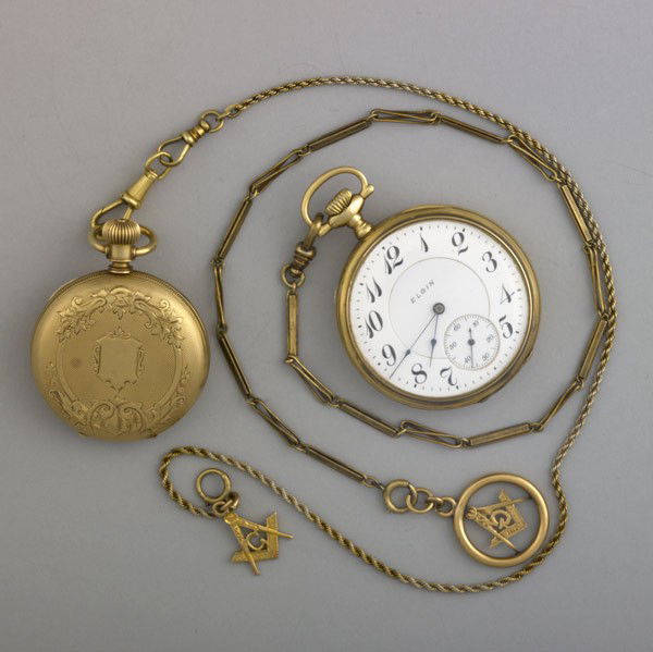 GOLD ELGIN POCKET WATCHES: GOLD ELGIN POCKET WATCHES. Two pocket watches: his/hers watches with chains and Masonic fobs, 14k yg. Chains: 24 gs. GW, total: 159.4 gs. GW, larger face: 40mm, longer fob chain, 15''