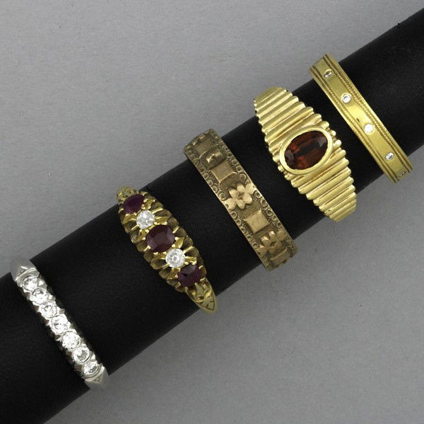 PLATINUM OR GOLD RINGS: PLATINUM OR GOLD RINGS. Five rings include: band in 10k yg, size 8 1/2; garnet in 14k yg, size 6; band with small diamonds in 14k yg, marked Cartier, size 6; diamond, approx. .10 ct. TW and ruby, appr