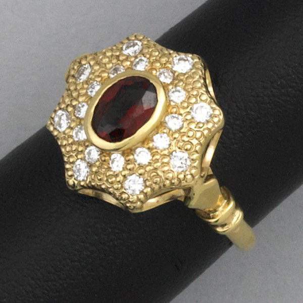 DIAMOND AND RED SPINEL RING: DIAMOND AND RED SPINEL RING. Red spinel surrounded by diamond accents in 14k yg. 4.7 gs. GW, size 6 1/2