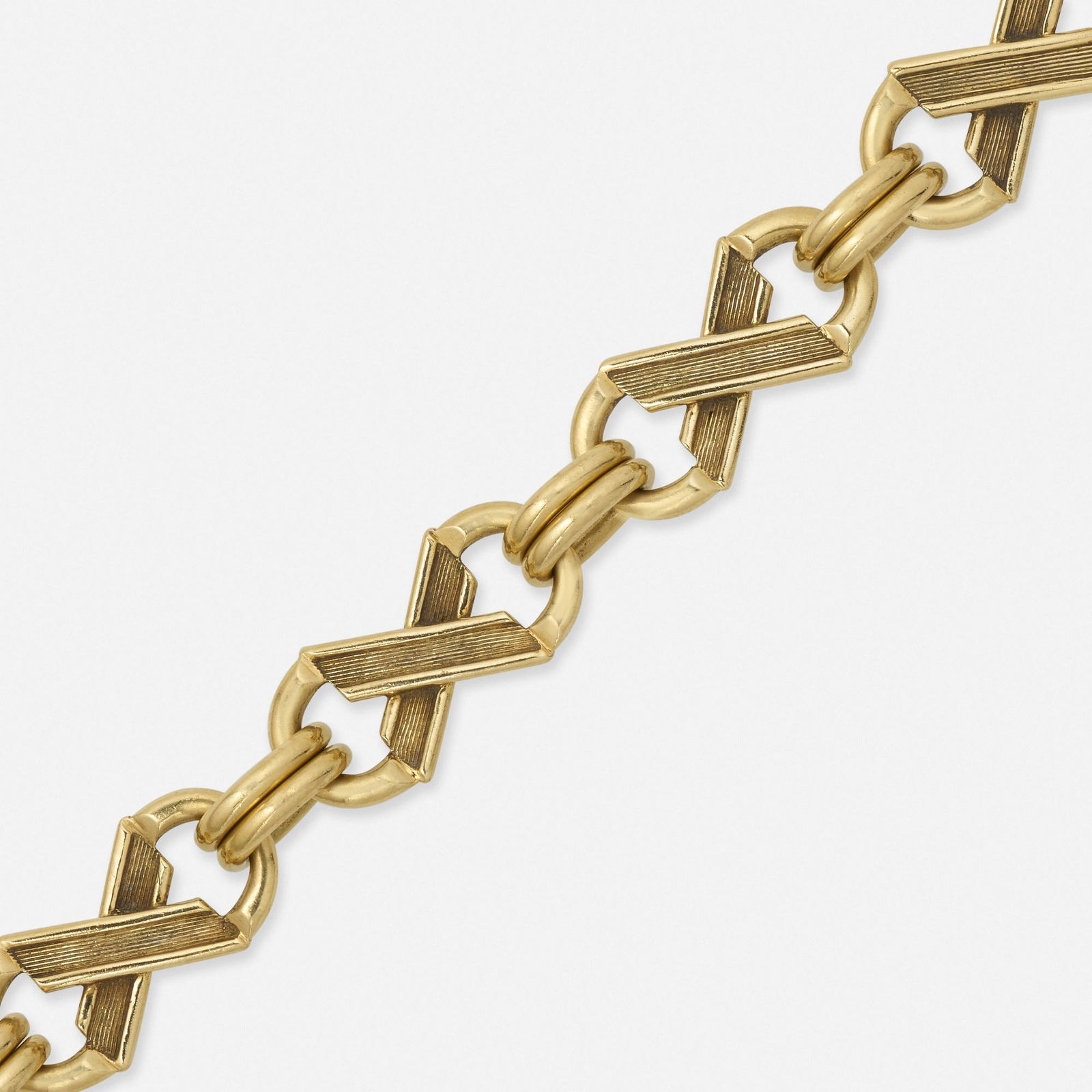 Jean Schlumberger for Tiffany & Co., 'XO's' bracelet: Jean Schlumberger for Tiffany & Co. 'XO's' gold bracelet Of stylized 'XO' links; 1970s 18k yellow gold Signed Tiffany Schlumberger 7 x 0.50 in; Gross weight 29.9 dwts