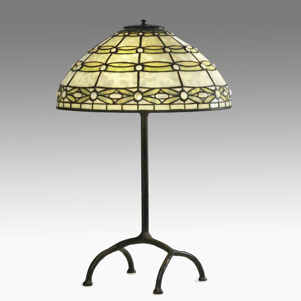 TIFFANY STUDIOS; Table lamp: TIFFANY STUDIOS; Table lamp, Colonial shade; Leaded glass, bronze; Shade and base marked TIFFANY STUDIOS NEW YORK; Shade: 7 1/4'' x 15 1/2'' dia., with base: 24''