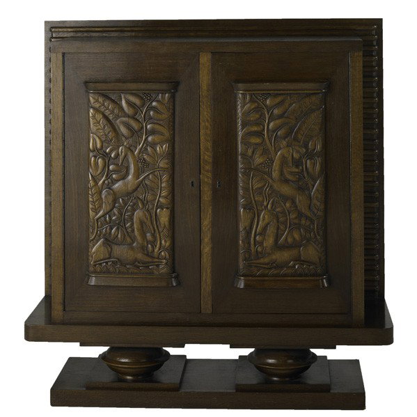 JACQUES KLEIN: JACQUES KLEIN; Carved Art Deco two-door cabinet in oak, fitted with two interior drawers and shelf, French, ca. 1939; 53 1/2'' x 51 1/4'' x 18''