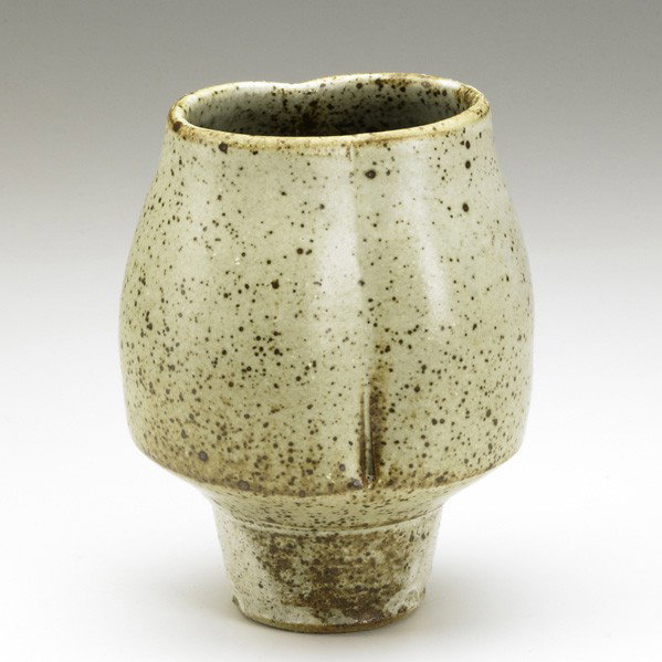 MODERN CERAMICS: WARREN MCKENZIE; Dimpled coupe-shaped stoneware vase with speckled brown over cream glaze; Raised mark; 6 3/4'' x 4'' x 3''