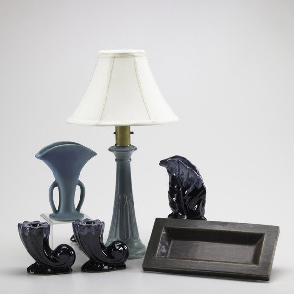 ROOKWOOD / VAN BRIGGLE: ROOKWOOD; VAN BRIGGLE; Six pieces: Rookwood production candlestick converted to a lamp and rectangular candy dish, Van Briggle two-armed fan vase, and Van Briggle three piece console set; All marked, 