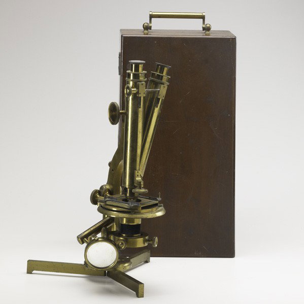 BRASS BINOCULAR MICROSCOPE: BRASS BINOCULAR MICROSCOPE; In fitted box with eight lenses, 19th c.; Manufactured by R & J Beck, London and Philadelphia, serial no. 8997; Marked; 15 1/2'' x 7'' x 8''