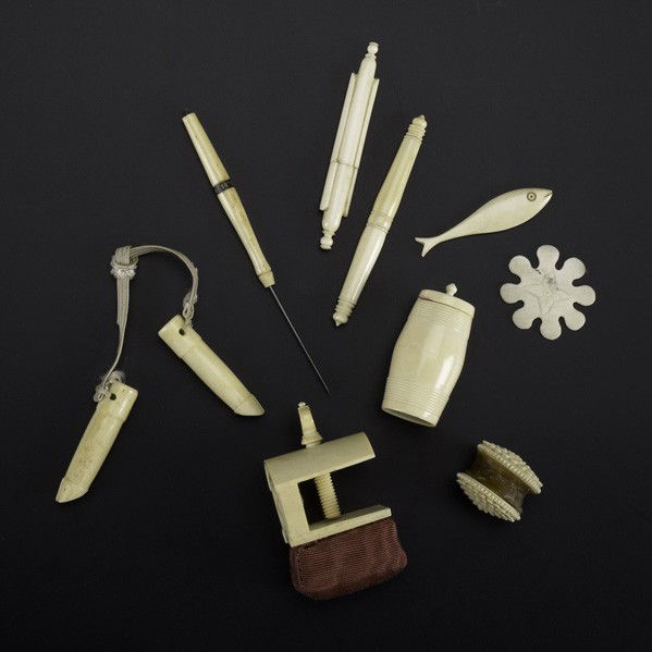 IVORY OR BONE SEWING UTENSILS: IVORY OR BONE SEWING UTENSILS; Nine pieces, 19th/20th c.: needle case, clamp, fish, point, pig's feet knitting needle holders, waxer, barrel-shaped thread holder, small needle case and flat winder; La