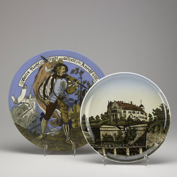METTLACH: METTLACH; Two chargers, early 20th c.: no. 1584 etched with a musketeer and no. 1044 ''Nurnberg Schloss''; Larger: 14 1/2''