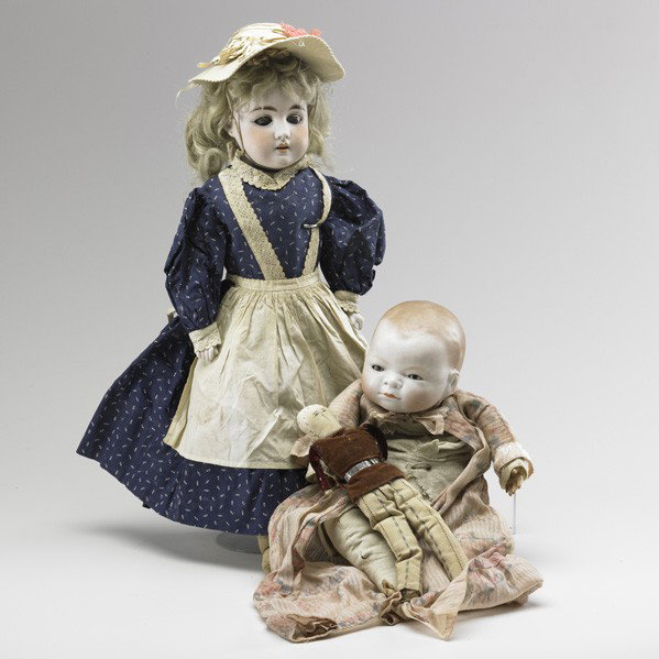 GERMAN BISQUE HEAD DOLLS: GERMAN BISQUE HEAD DOLLS; Two, early 20th c.: Grace S. Putnam Bye-Lo baby and bisque head and shoulder doll in original clothing; With additional clothes; Both marked; Taller: 22''