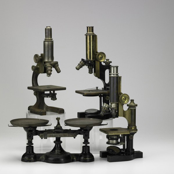 THREE MONOCULAR MICROSCOPES: THREE MONOCULAR MICROSCOPES; Manufactured by Arthur H. Thomas & Co., Philadelphia, Bausch & Lomb and Spencer, late 19th/early 20th c.; Together with a Fairbanks apothecary scale; Tallest: 14''