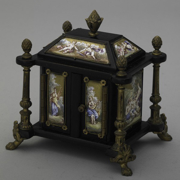 VIENNESE ENAMEL AND GILT BRONZE MINIATURE CABINET: VIENNESE ENAMEL AND GILT BRONZE MOUNTED MINIATURE CABINET, ca. 1880. Ebonized wood cabinet on claw feet, interior fitted with two drawers. All surfaces set with scenic or figural gilded plaques depict