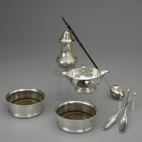 ENGLISH SILVER: ENGLISH SILVER, 17th-20th Century. Early double spout gravy pitcher with ring handles, unidentified London marks, possibly 16th century; pair of bottle coasters, Henry Sardet, London, 1802; crested ma