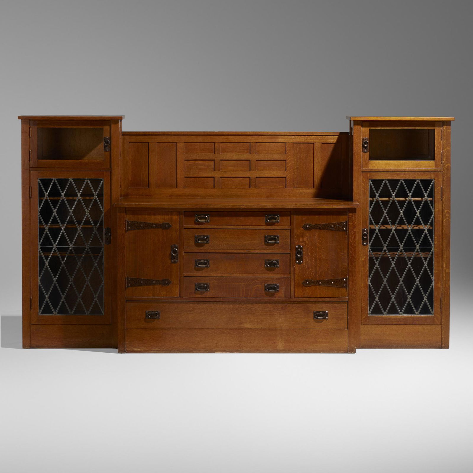 Gustav Stickley, Rare sideboard and china cabinets from the Charles B. Evans House, Queens: Gustav Stickley Rare sideboard and china cabinets from the Charles B. Evans House, Queens USA, c. 1914oak, glass, hammered copper, leading 58.25 h x 109 w x 22.5 d in (148 x 277 x 57 cm) Sideb