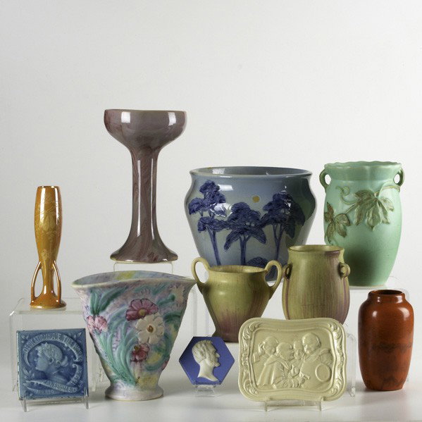 WELLER, ETC: WELLER, ETC; Eleven pieces: Weller Jap Birdimal jardiniere, three relief-decorated tiles, marbleized chalice, two vases in pink and light green matte, Lustre candlestick, Silvertone vase, Blo'Red vase