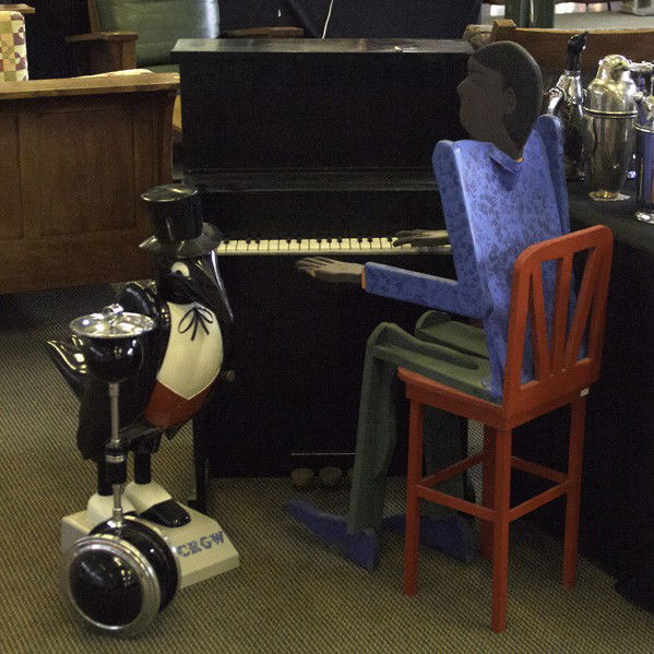 BARWARE AND ACCESSORIES: BARWARE AND ACCESSORIES; Three folk art pieces, 20th c.: man playing piano, rolling art deco cigar holder/ashtray, lifesize Old Crow statue;Piano signed Erwin Perton; Tallest: 41''