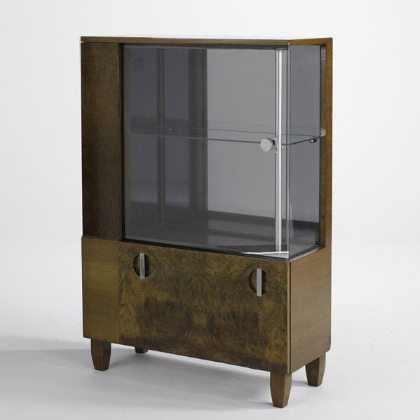 GILBERT ROHDE; HERMAN MILLER: GILBERT ROHDE; HERMAN MILLER; Display cabinet, USA, 1940s; Burl, mahogany, brushed steel and glass; Unmarked; 52 1/2'' x 46'' x 14''