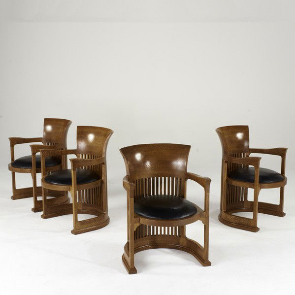 FRANK LLOYD WRIGHT; JOHN WIDDICOMB: FRANK LLOYD WRIGHT; JOHN WIDDICOMB; Set of four barrel chairs, USA, 1990s; Oak and leather; One with brass label; 31 1/2'' x 22 1/2'' x 25''