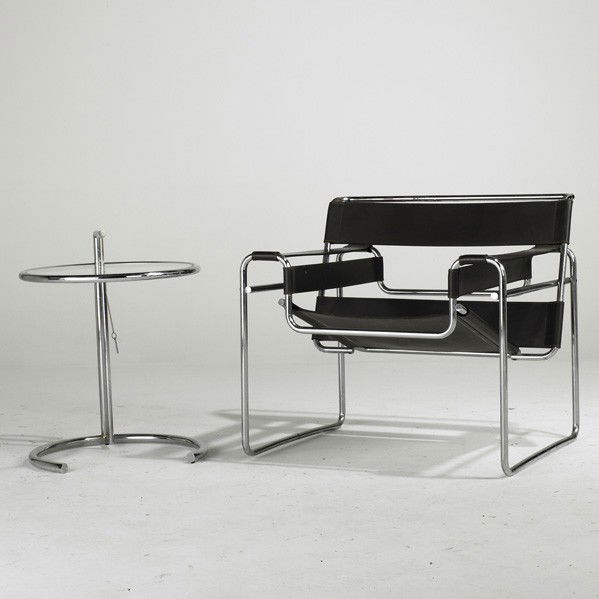 MARCEL BREUER AND EILEEN GRAY: MARCEL BREUER AND EILEEN GRAY; Wassily lounge chair and adjustable side table, USA, 1970s; Chromed steel, leather and glass; Knoll label on chair; Chair: 29'' x 31'' x 27'' and table: 26'' x 20 1/2''