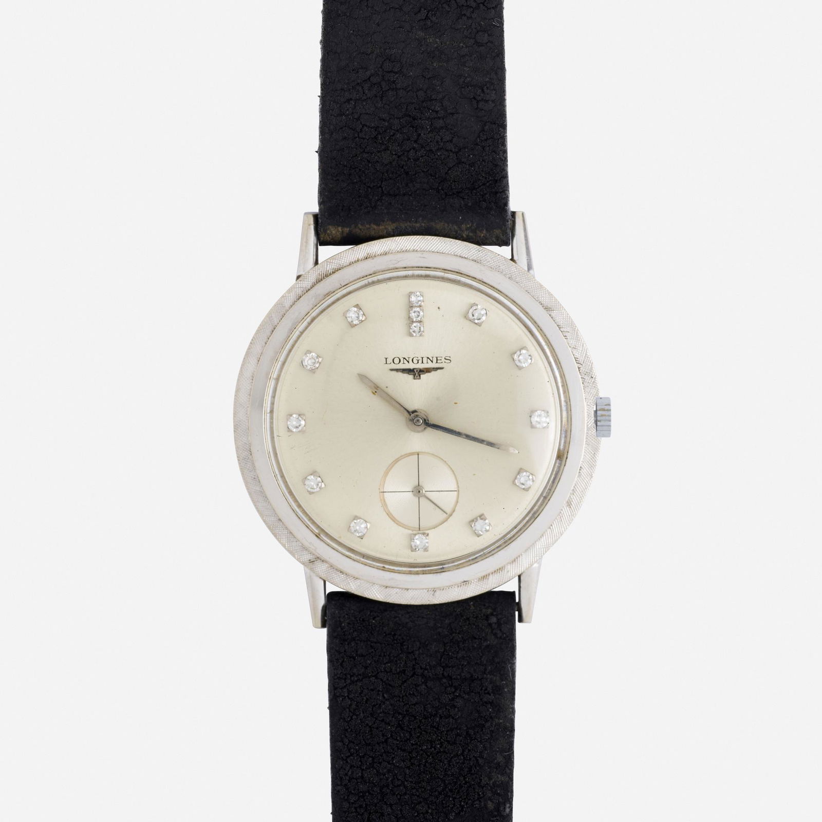 Longines, White gold and diamond wristwatch: Longines White gold and diamond wristwatch The round silvered dial with single-cut diamond hours and subsidiary seconds, to the textured white gold case Manual wind Case size 33.50 mm; 1960s 14k white