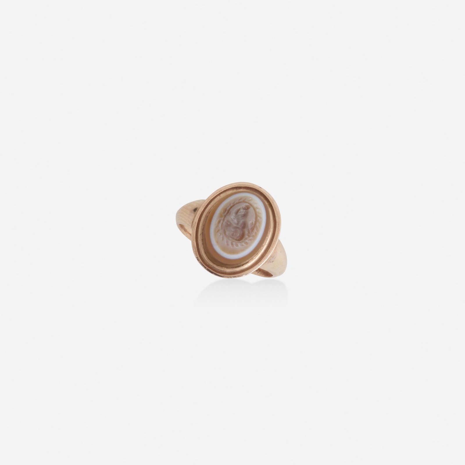 Agate intaglio and pink gold ring: Agate intaglio and pink gold ring The oval agate intaglio depicting a deity, in an antique pink gold setting, c. 19th Century Pink gold Ring size 4; Gross weight 2.3 dwts