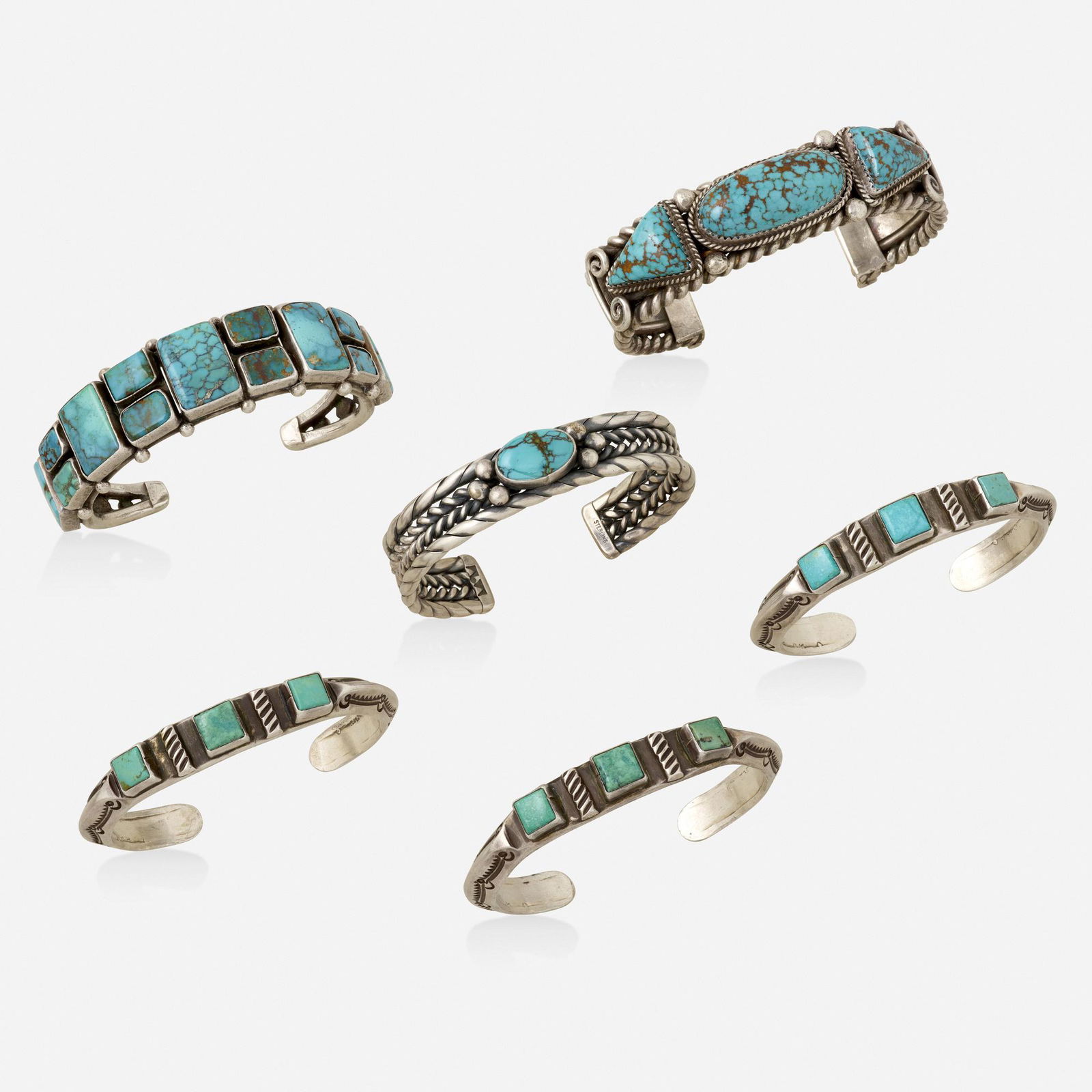 Six sterling silver and turquoise cuff bracelets: Six sterling silver and turquoise cuff bracelets Each set with polished turquoise and various stamped, roped, or beaded silver decorations Sterling silver Inner circ. 6 - 6.25 in; Gross weight 176.3 d
