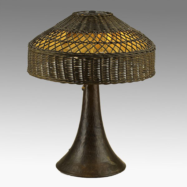 GUSTAV STICKLEY; Table lamp: GUSTAV STICKLEY; Table lamp, Eastwood, NY, ca. 1910; Hammered copper, two-sockets, replaced wicker shade; Unmarked; 19'' x 14''