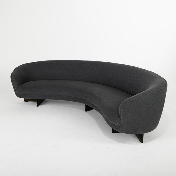 VLADIMIR KAGAN; Sofa: VLADIMIR KAGAN; KAGAN-DREYFUSS INC; Curva sofa (no. 6999), USA, 1950s; Sculpted walnut, microfiber; Unmarked; 28 1/2'' x 110 1/2'' x 48'', seat depth: 20 1/2'', seat height: 18''