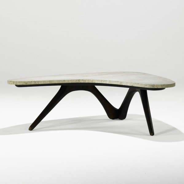 VLADIMIR KAGAN; Coffee table: VLADIMIR KAGAN; KAGAN-DREYFUSS; Boomerang coffee table, USA, 1950s; Sculpted walnut, travertine; Unmarked; 14'' x 51'' x 43 1/2''