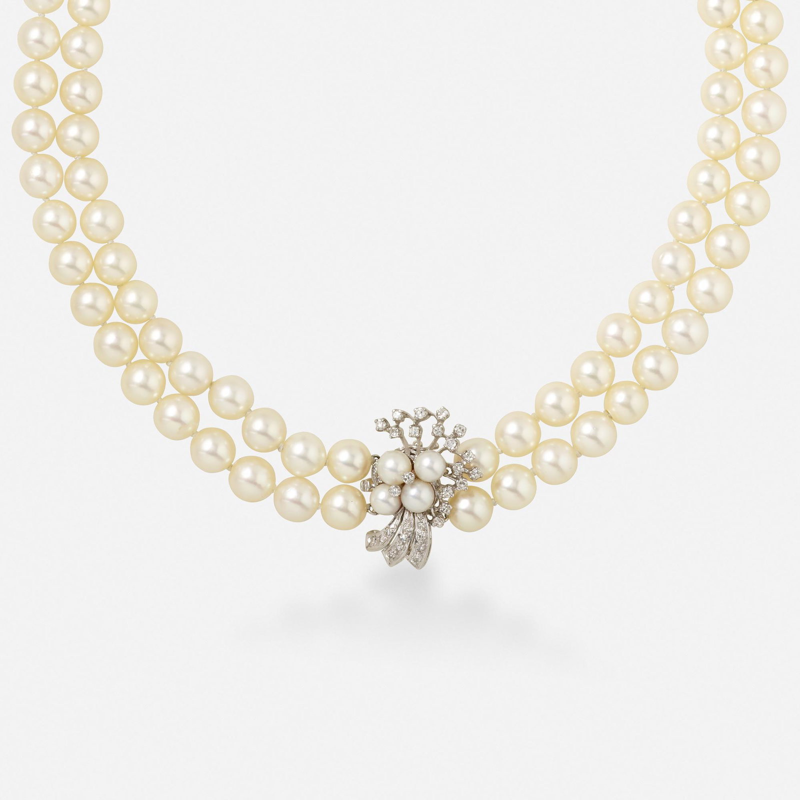 Cultured pearl, diamond, and white gold necklace: Cultured pearl, diamond, and white gold necklace The two strands of 49 and 53 cultured pearls, measuring approx. 7.6 mm, with a single-cut diamond and cultured pearl clasp 14k white gold 16 in; Gross 