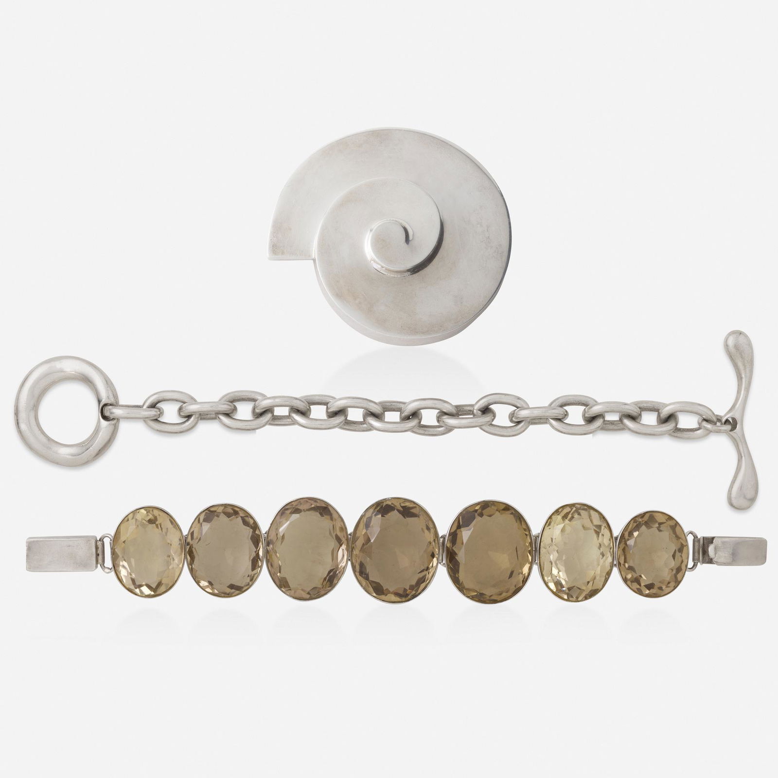 Robert Lee Morris, Two bracelets and brooch: Robert Lee Morris Sterling silver bracelet with quartz bracelet and silver brooch Comprising a Mexican silver swirl brooch, a toggle bracelet by Robert Lee Morris; and a bracelet set with seven large