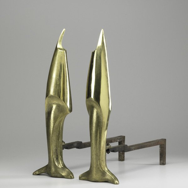 STYLE OF PIERRE LEGRAIN; Pair of andirons; Cast bra: STYLE OF PIERRE LEGRAIN; Pair of andirons; Cast brass, iron; Each: 21'' x 7'' x 18''