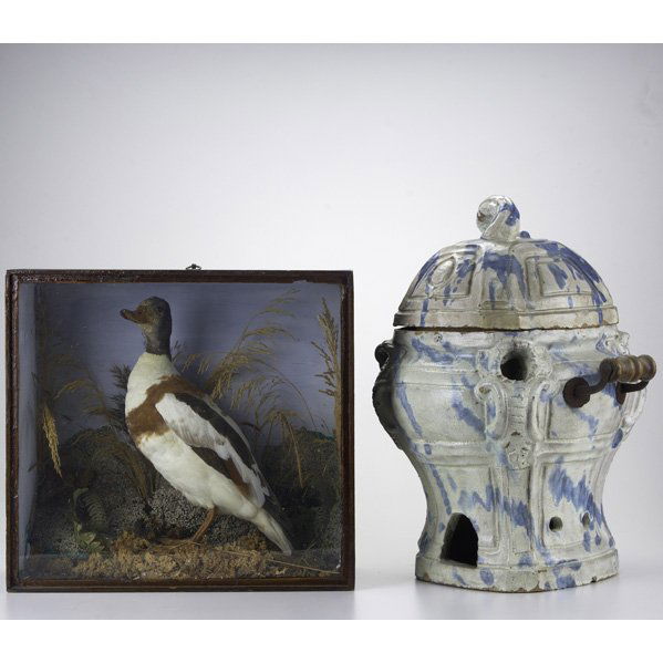 DECORATIVE ARTS; Two pieces, 19th/20th c.: Italian: DECORATIVE ARTS; Two pieces, 19th/20th c.: Italian faience furnace with blue and white glazing together with taxidermy duck diorama; Taller: 19''