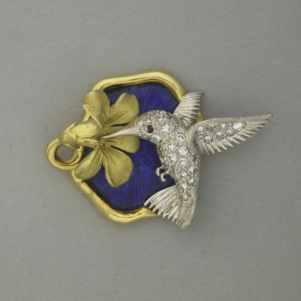 SCHULER-MCTEIGUE JEWELED GOLD & PLATINUM ORNAMENT: SCHULER-MCTEIGUE JEWELED GOLD AND PLATINUM ORNAMENT, 1975-1991; Diamond pave platinum hummingbird with ruby eye sips nectar from sculpted 18k yg. blossom above blue guilloche enamel ground; 7.0 dwt. (