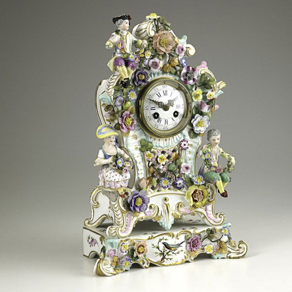 MEISSEN: MEISSEN; Shelf clock with seated figures and applied floral decoration, French time and strike movement, 19th c.; Crossed swords mark; 15'' x 9'' x 6''